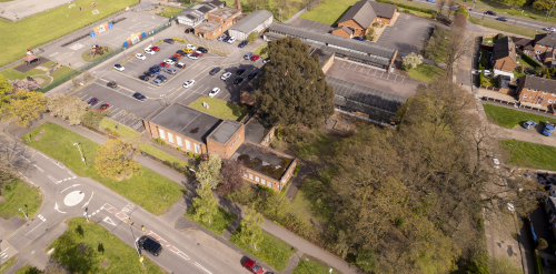 This image: An aerial photo of the site taken from the southwest, overlooking the trees and hedge 
						 in the corner of the site.
						 The map: The map shows the artist's watercolour sketch of how the trees and open space in the 
						 corner of the site could look, with interactive map labels highlighting key aspects of the proposed
						 landscaping.